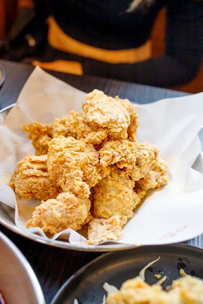Delicious crispy fried chicken served on a paper-lined plate, ready to enjoy.
