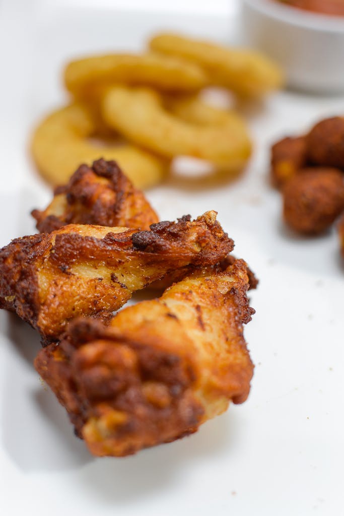 Delicious crispy fried chicken served with onion rings and dipping sauces.