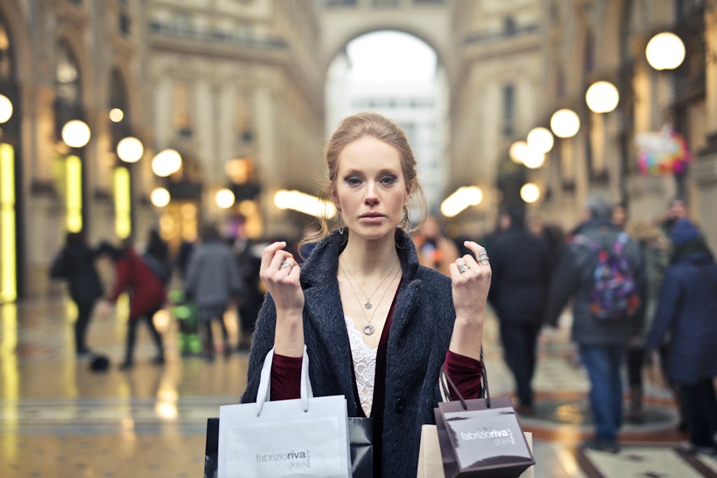 Elegant woman shopping with bags in Milan's iconic Galleria Vittorio Emanuele II.