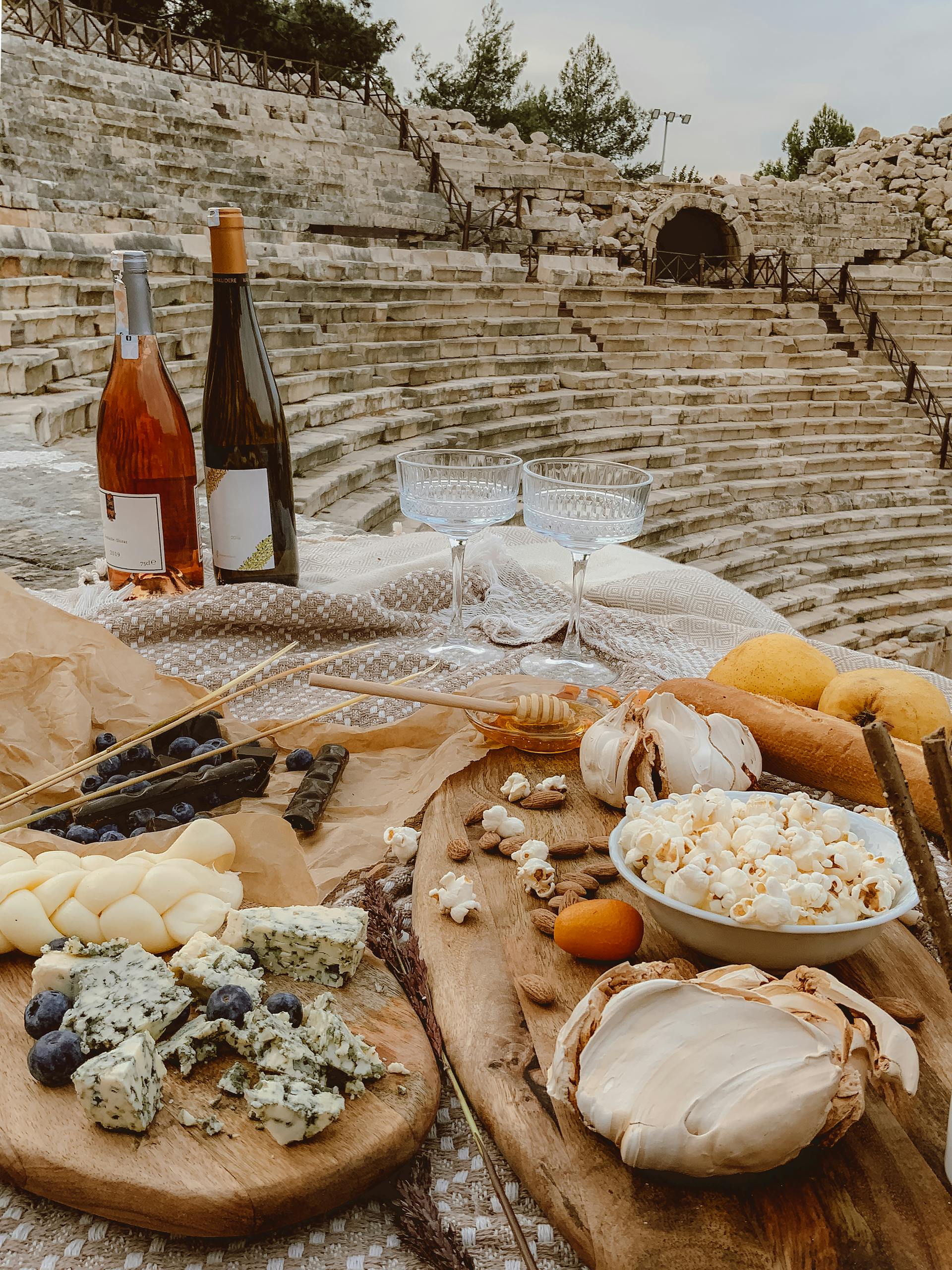 Enjoy a rustic picnic with gourmet cheese, wine, and snacks at an ancient amphitheater in Kaş, Turkey.