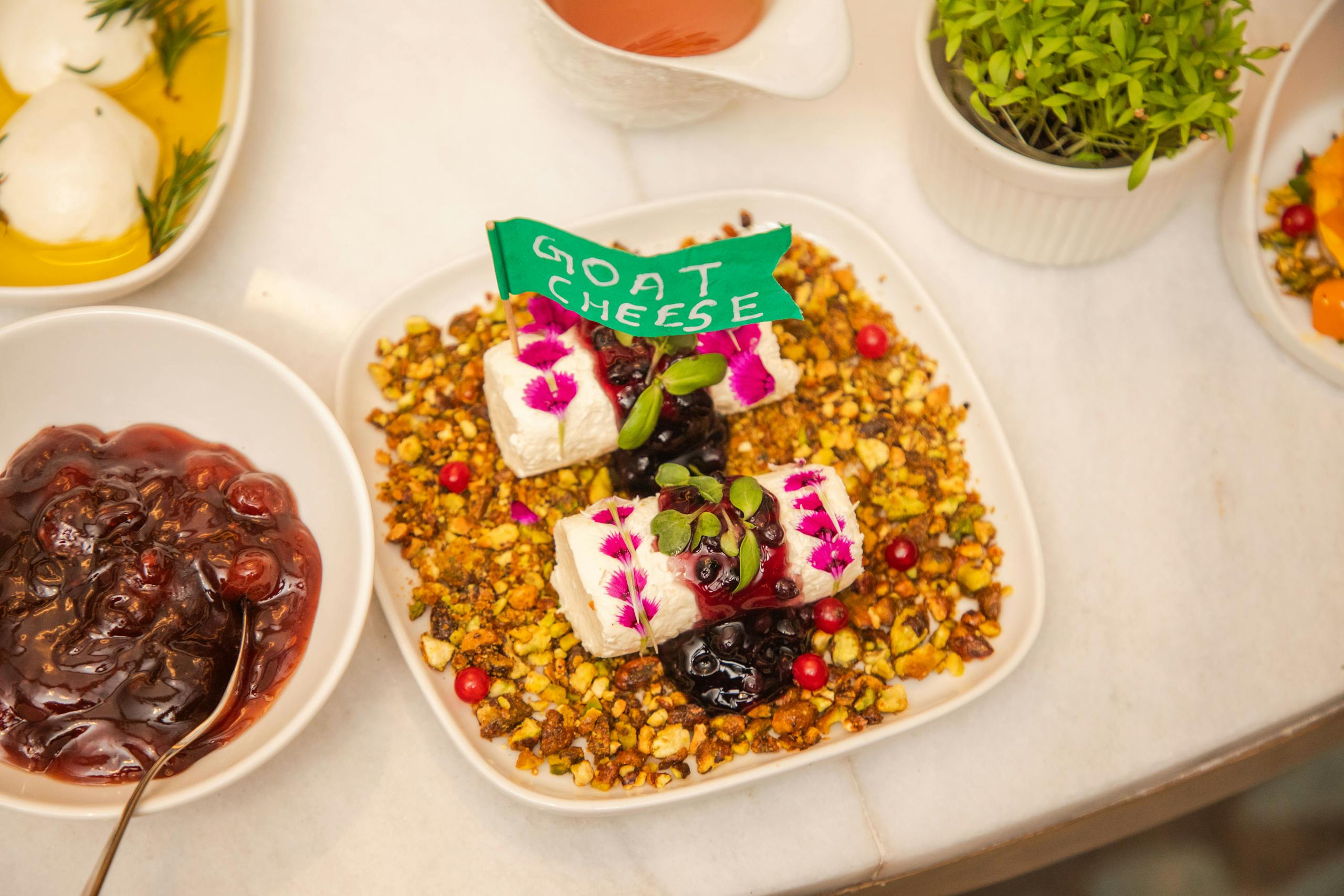 Exquisite goat cheese platter garnished with berries and nuts, perfect for a gourmet meal.