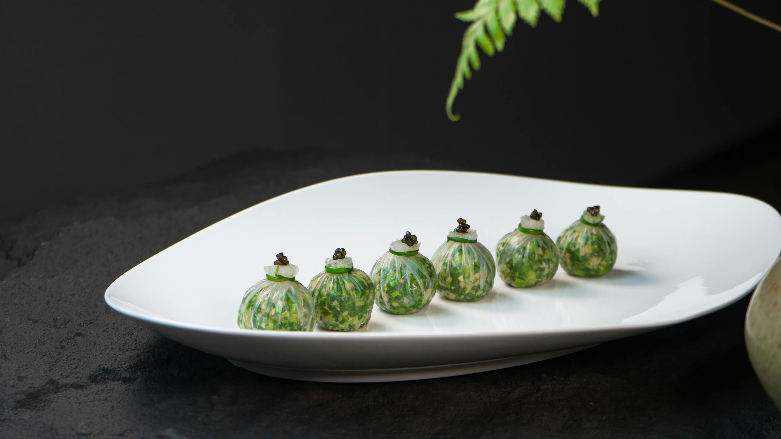Exquisite gourmet dish artistically presented on a sleek white plate, perfect for culinary themes.