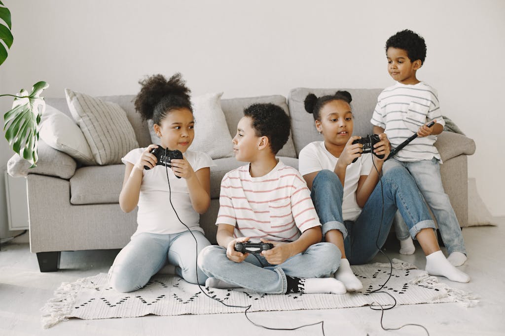 Four children playing video games together in a cozy living room setting.