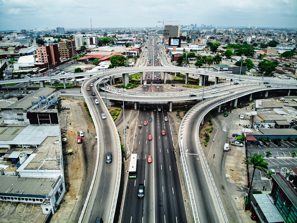 High-angle view of a busy expressway in Abidjan, showcasing urban infrastructure and traffic.