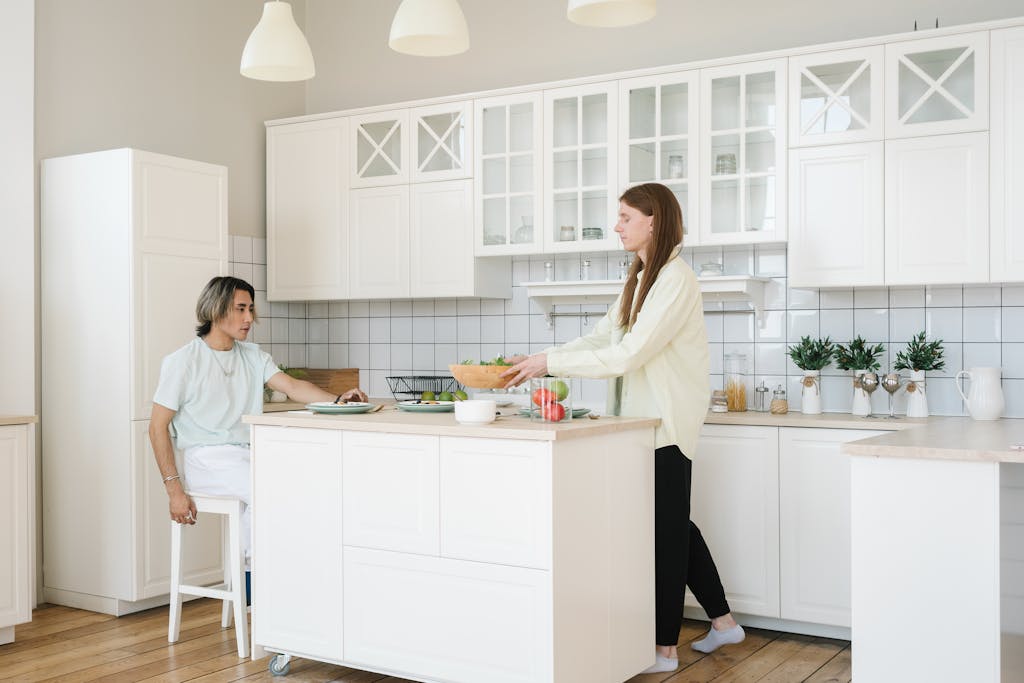 Interracial couple preparing a healthy meal together in a bright, modern kitchen setting.