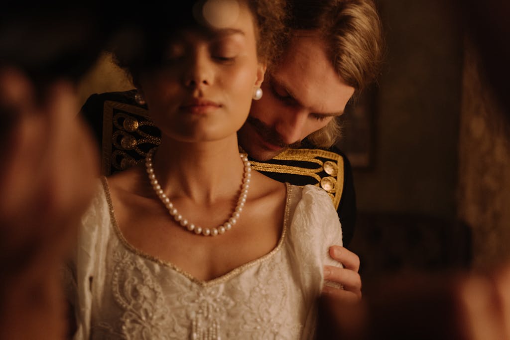 Intimate moment with a couple in period costume, exuding romance and elegance.