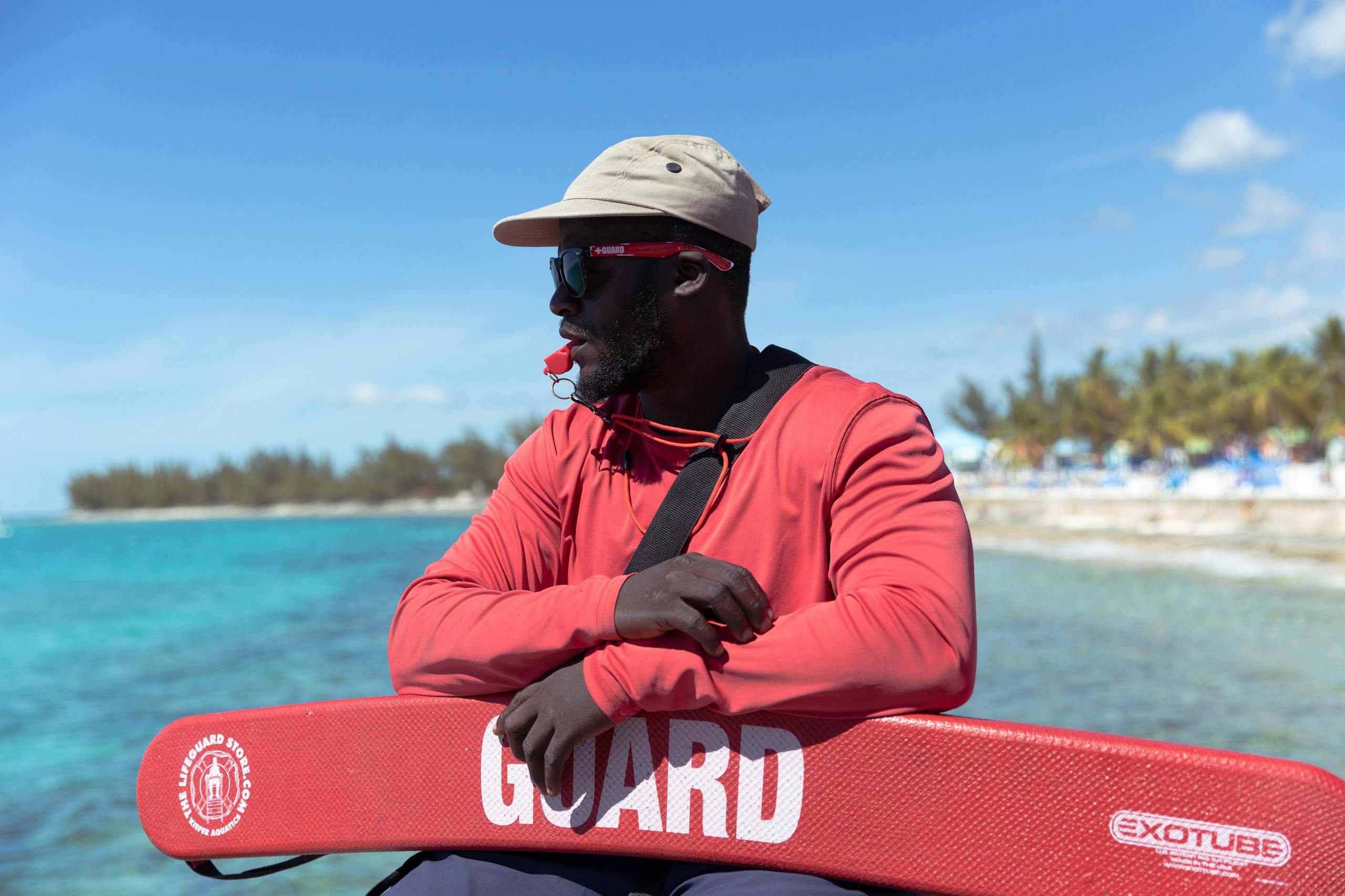 Lifeguard overlooking tropical waters in the Bahamas, ensuring safety on a sunny day.