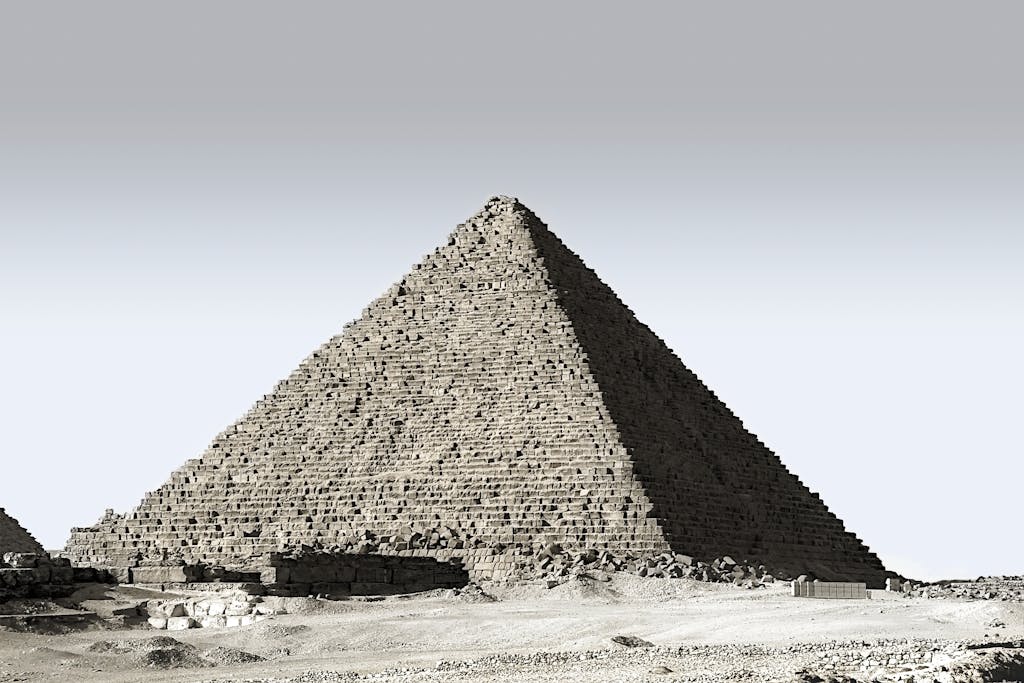 Majestic view of the Great Pyramid of Giza standing prominently in the Egyptian desert under a clear sky.
