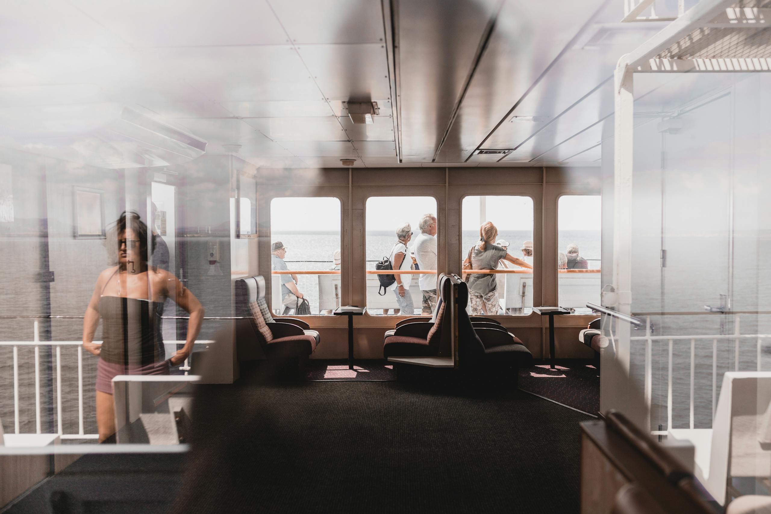 Passengers enjoy a sunny ferry ride with sea views in Sardinia, Italy