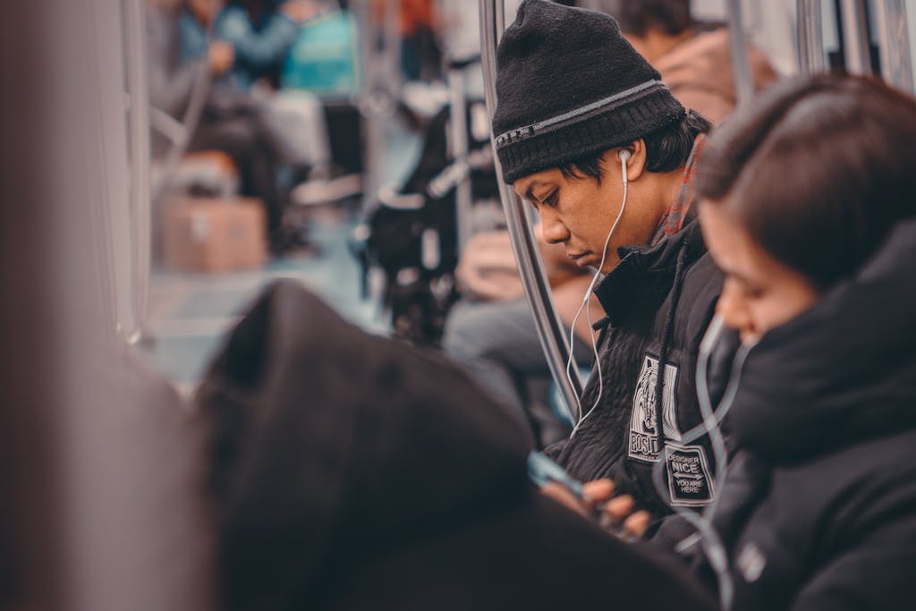 Passengers listen to music on a public transportation vehicle in Beijing, China.