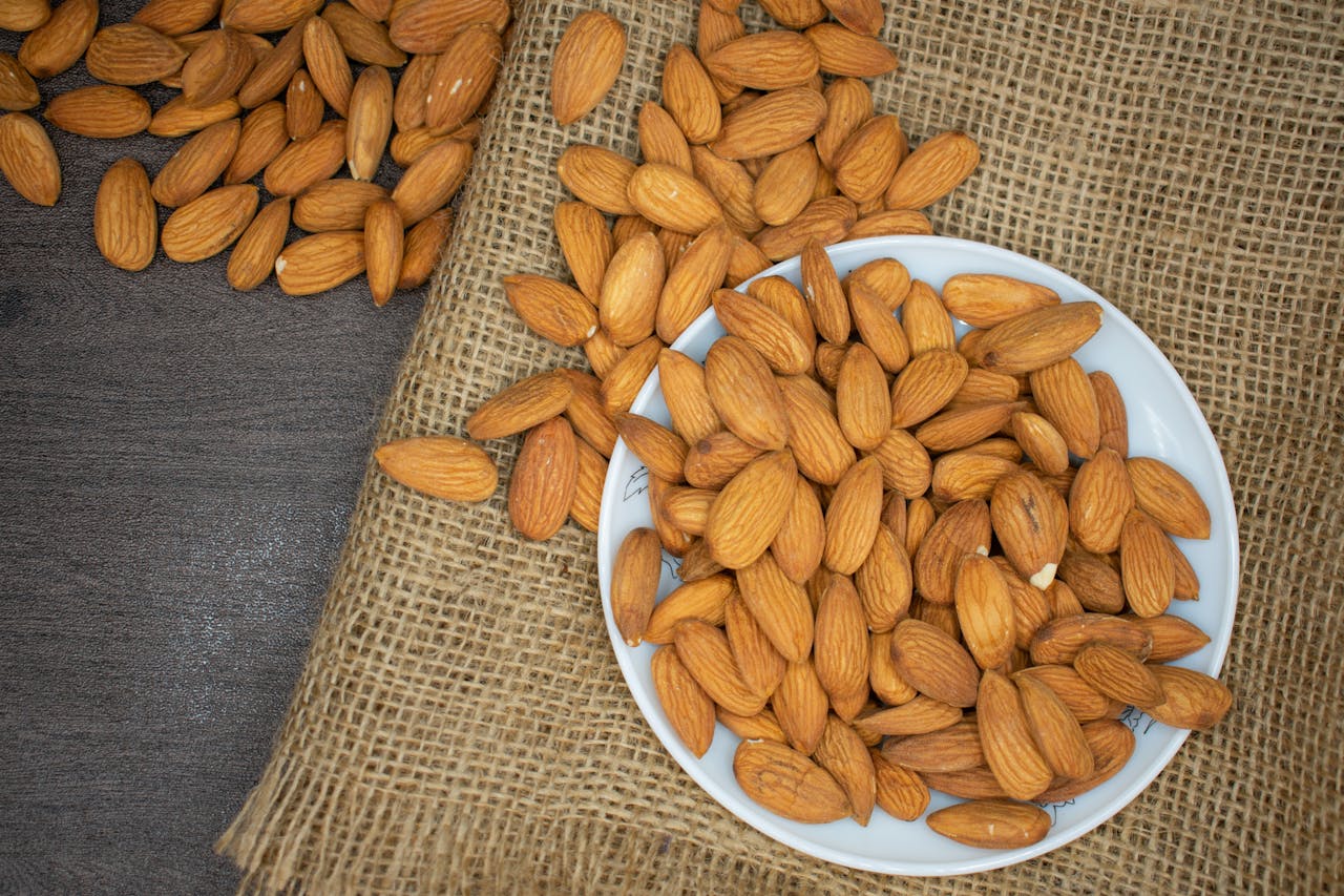 brown-almond-nuts-on-white-plate-