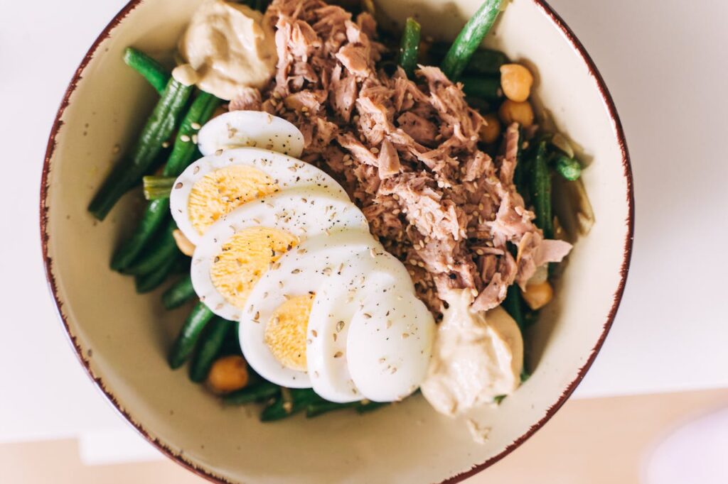 /tuna-and-green-beans-with-egg-salad-in-ceramic-bowl-