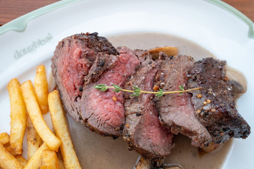 juicy-sliced-beef-steak-with-crispy-fries-