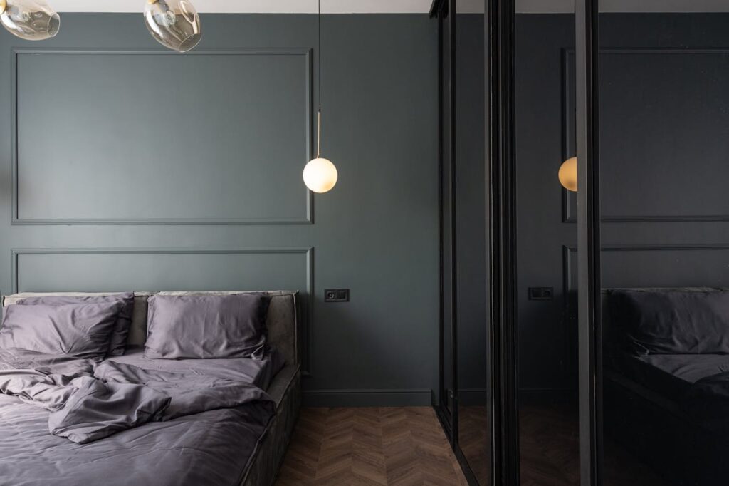 stylish-bedroom-with-unmade-bed-near-cupboard