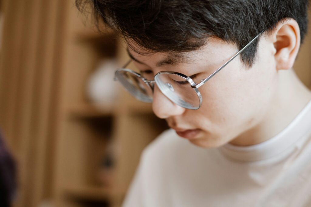 man-in-white-crew-neck-shirt-wearing-gray-framed-eyeglasses-