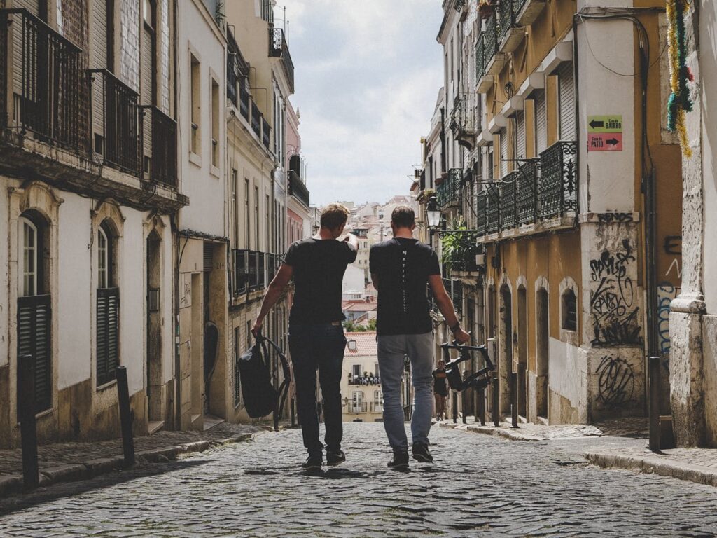 two-man-walking-in-between-of-buildings-toward-with-concrete-building-