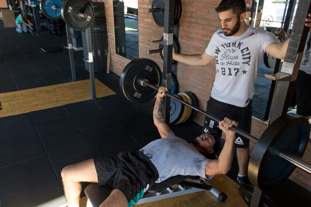 man-lying-while-doing-barbell-