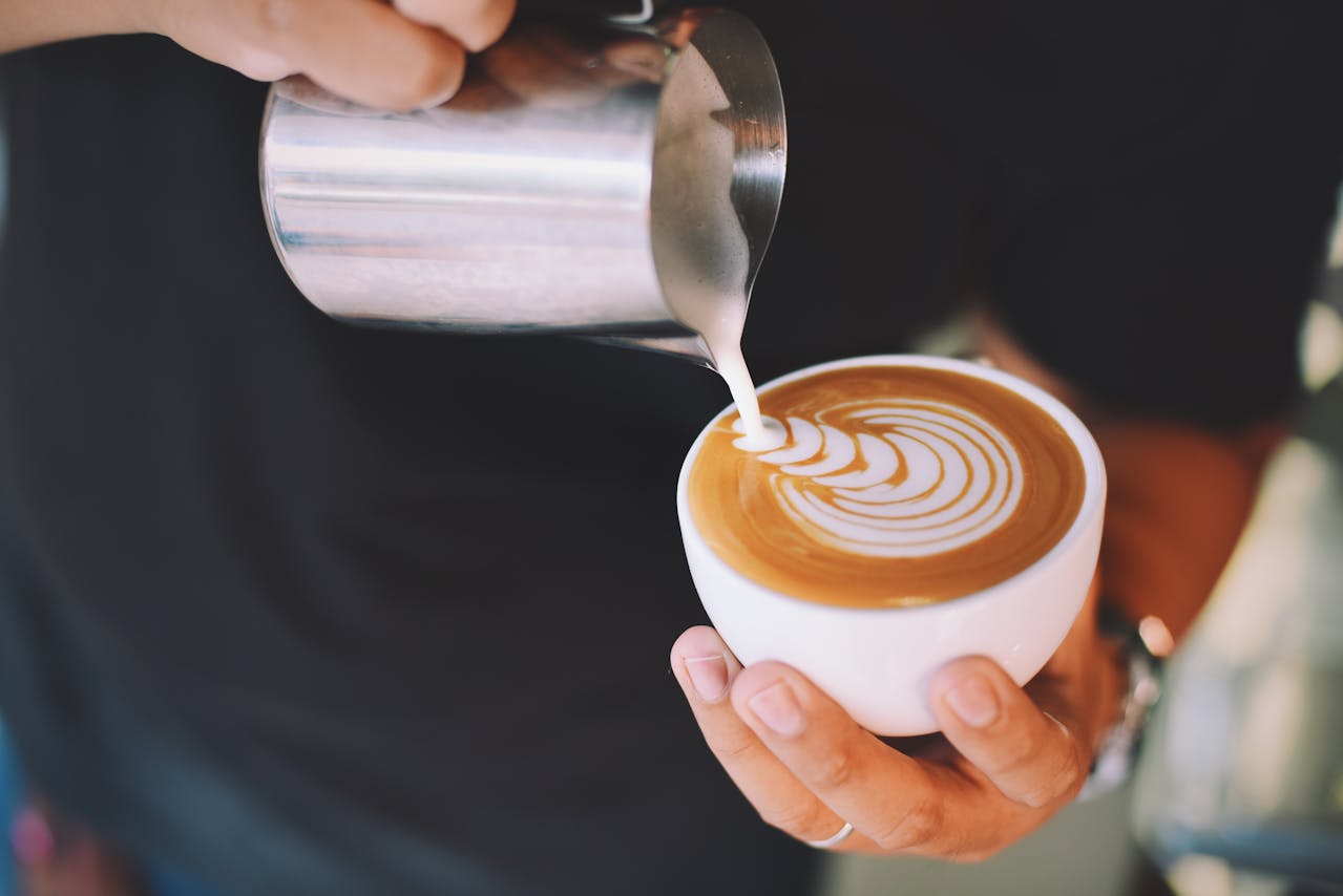 person-holding-white-cup