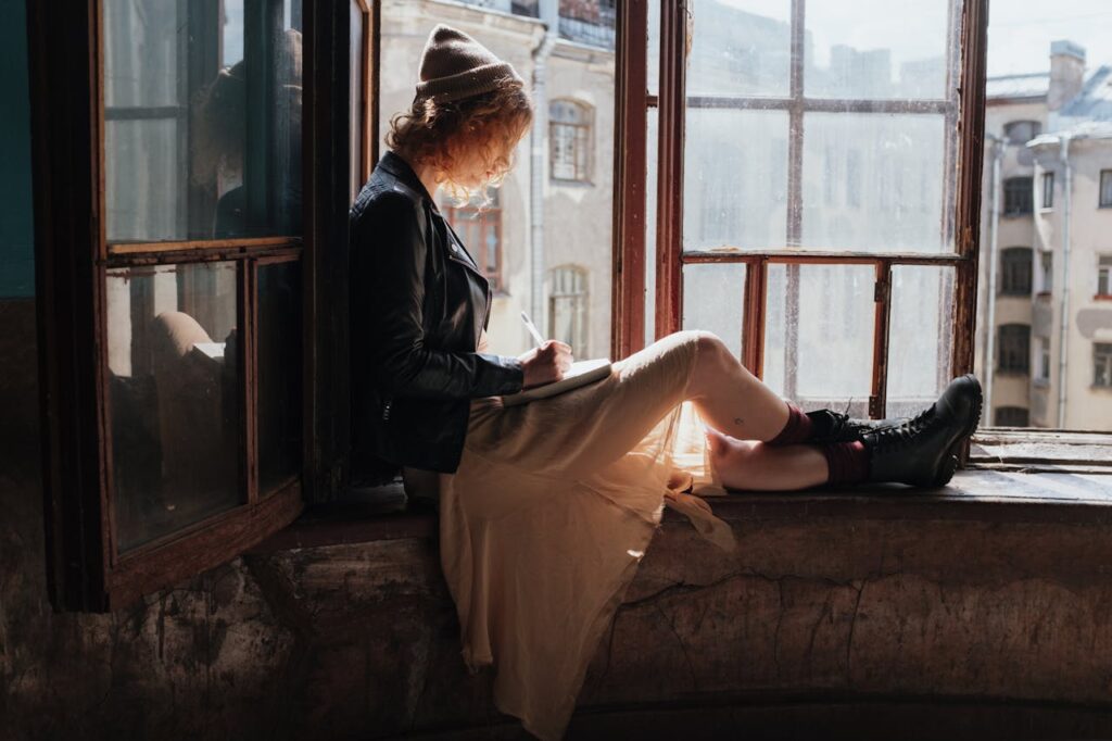 /woman-in-black-jacket-sitting-on-brown-couch-