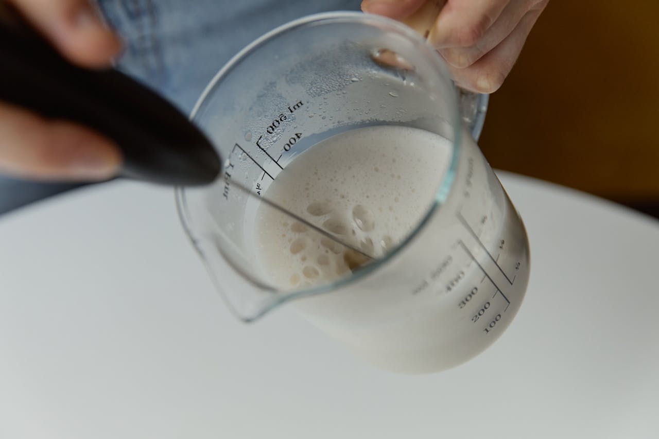 a-person-holding-glass-measuring-cup-