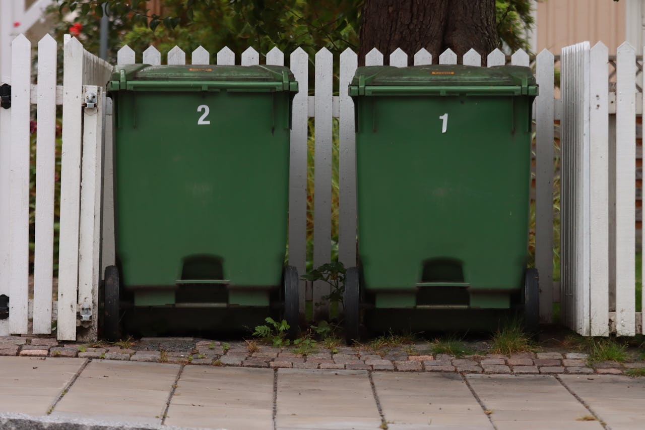 /green-trash-bins-on-gray-concrete-floor-