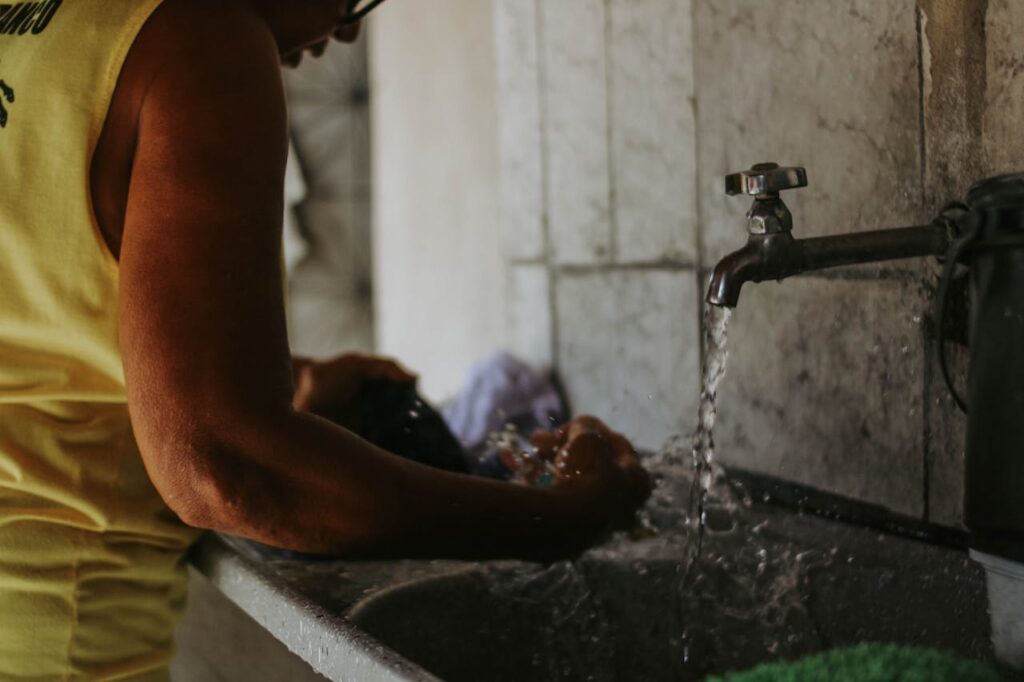 person-handwashing-clothes-in-indoor-setting-