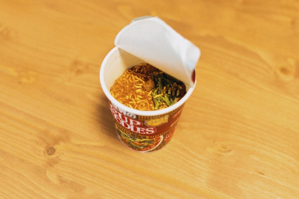 open-cup-of-instant-noodles-on-wooden-table-