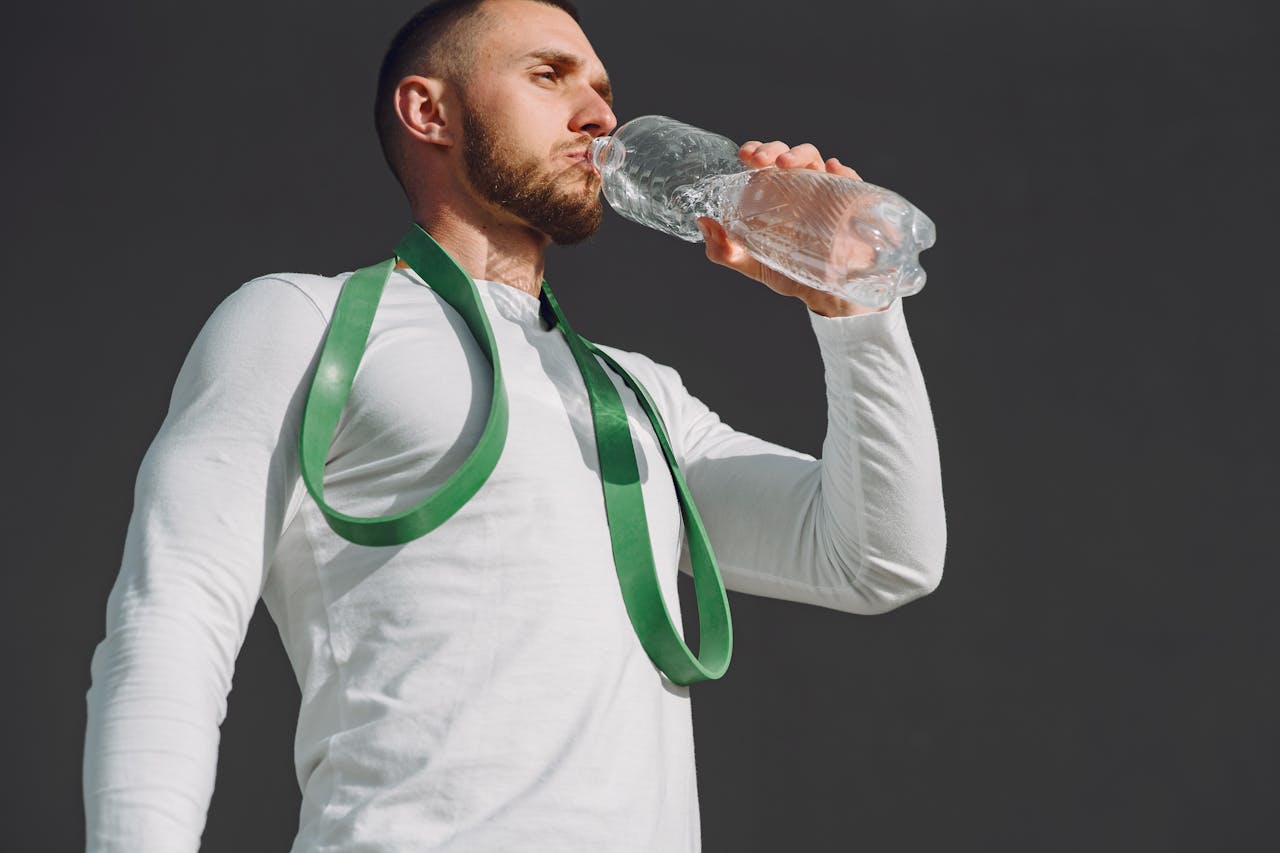 /a-man-drinking-water-from-a-bottle