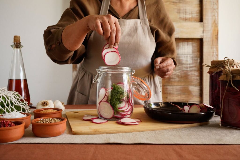 woman-preparing-pickled-radishes-in-rustic-kitchen