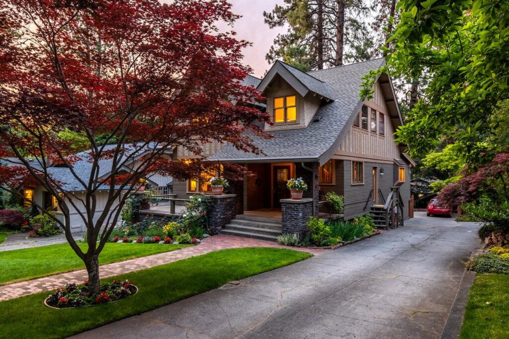 brown-and-white-wooden-house-near-green-trees-