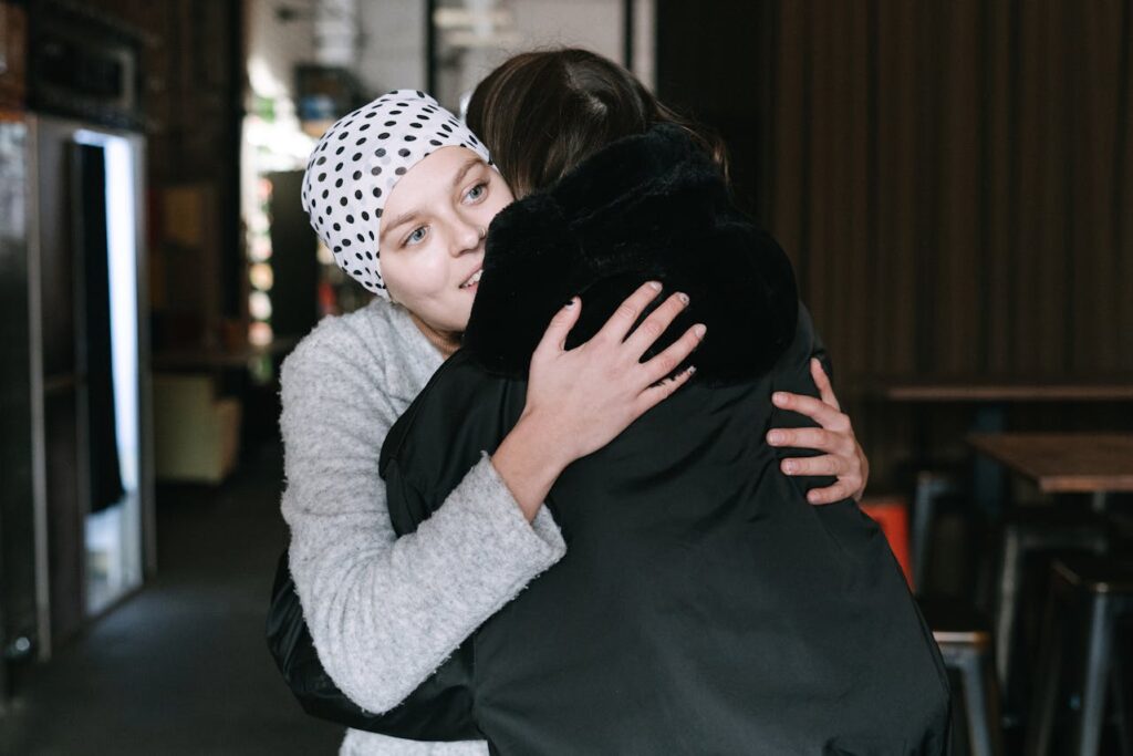 /close-up-shot-of-two-people-hugging-each-other-
