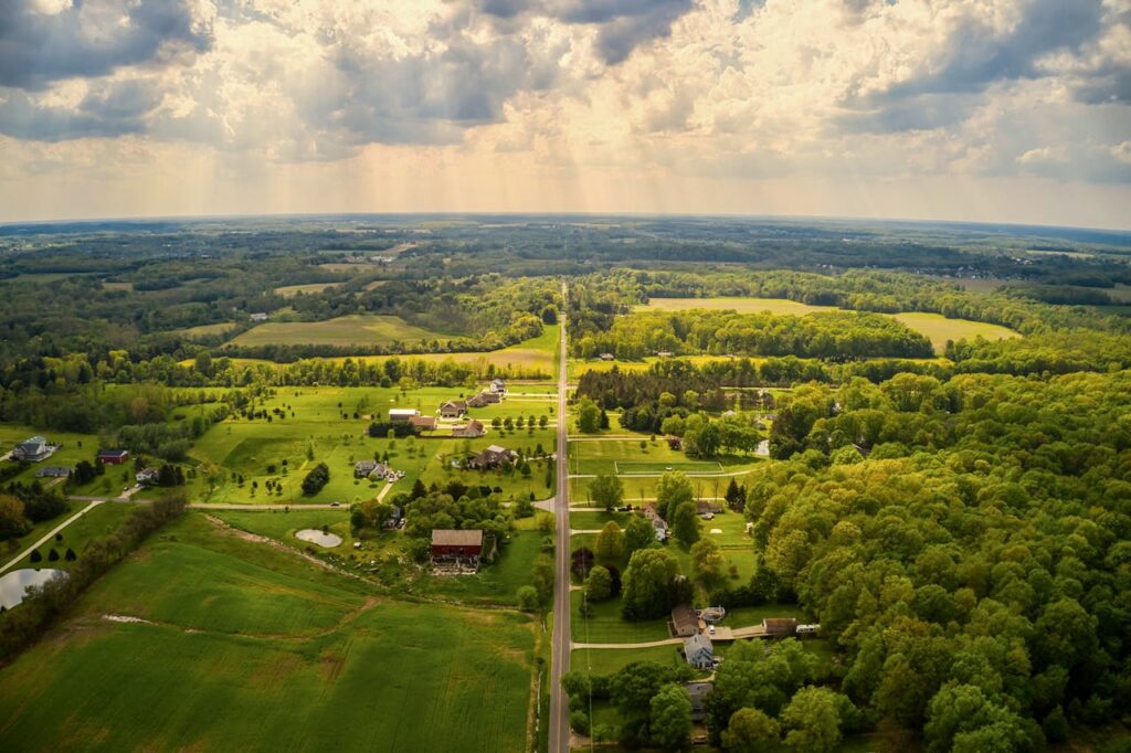 aerial-view-of-green-trees-and-green-grass-field-