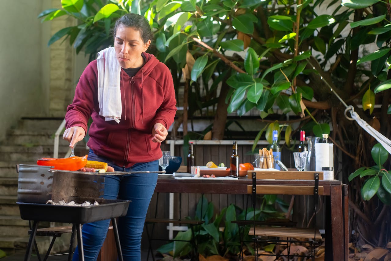 woman-putting-a-pepper-on-the-barbecue-