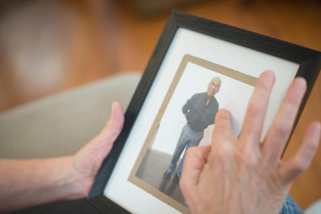 person-touching-photo-in-the-picture-frame-