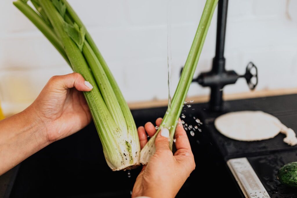 woman-washing-celery-in-kitchen-