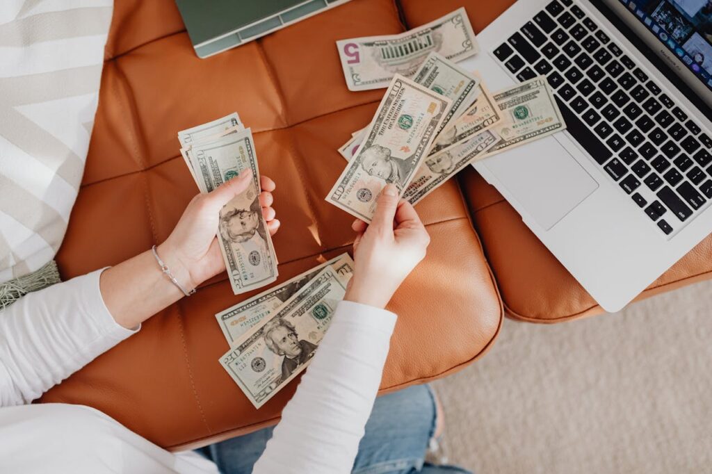 /close-up-of-woman-counting-dollar-bills-