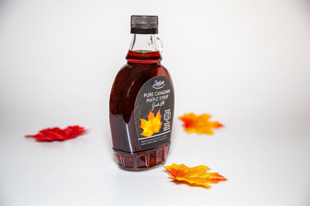 /maple-leaves-around-maple-syrup-bottle-
