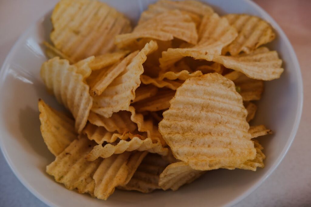 close-up-of-crunchy-ridged-potato-chips-in-bowl-
