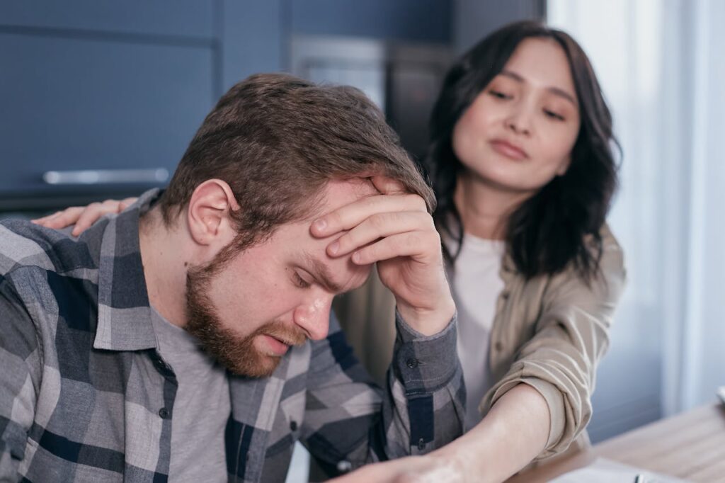 a-woman-holding-a-stressed-man-