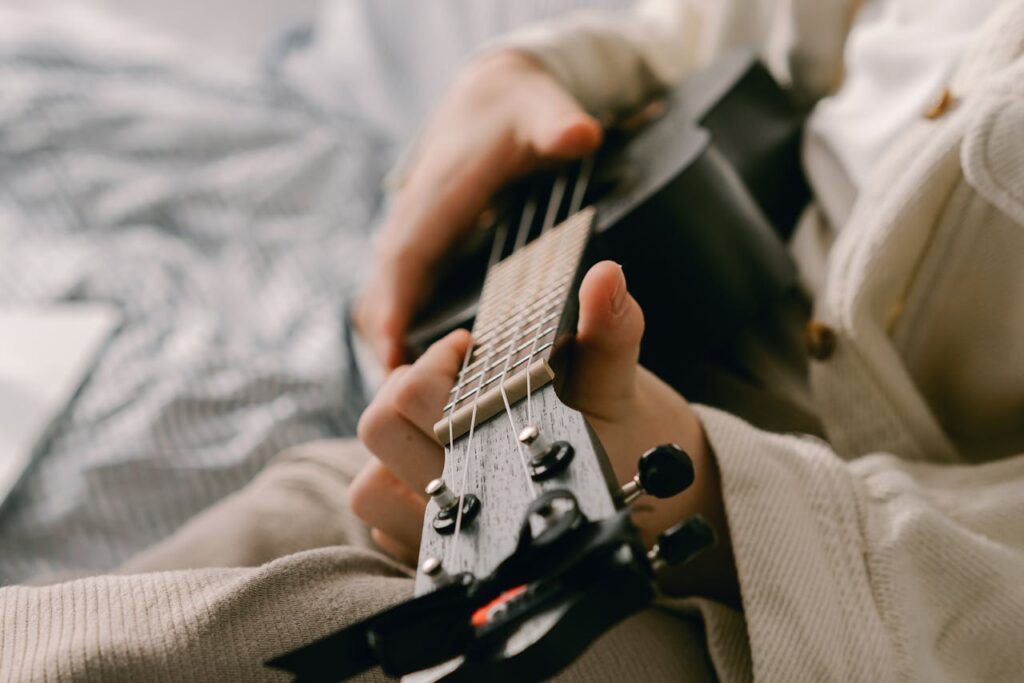 /close-up-shot-of-a-person-playing-ukelele-
