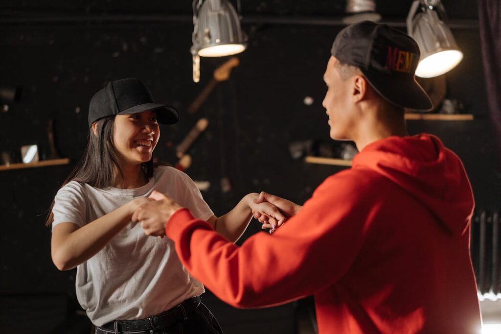 man-and-woman-wearing-black-caps-holding-hands-while-looking-at-each-other-
