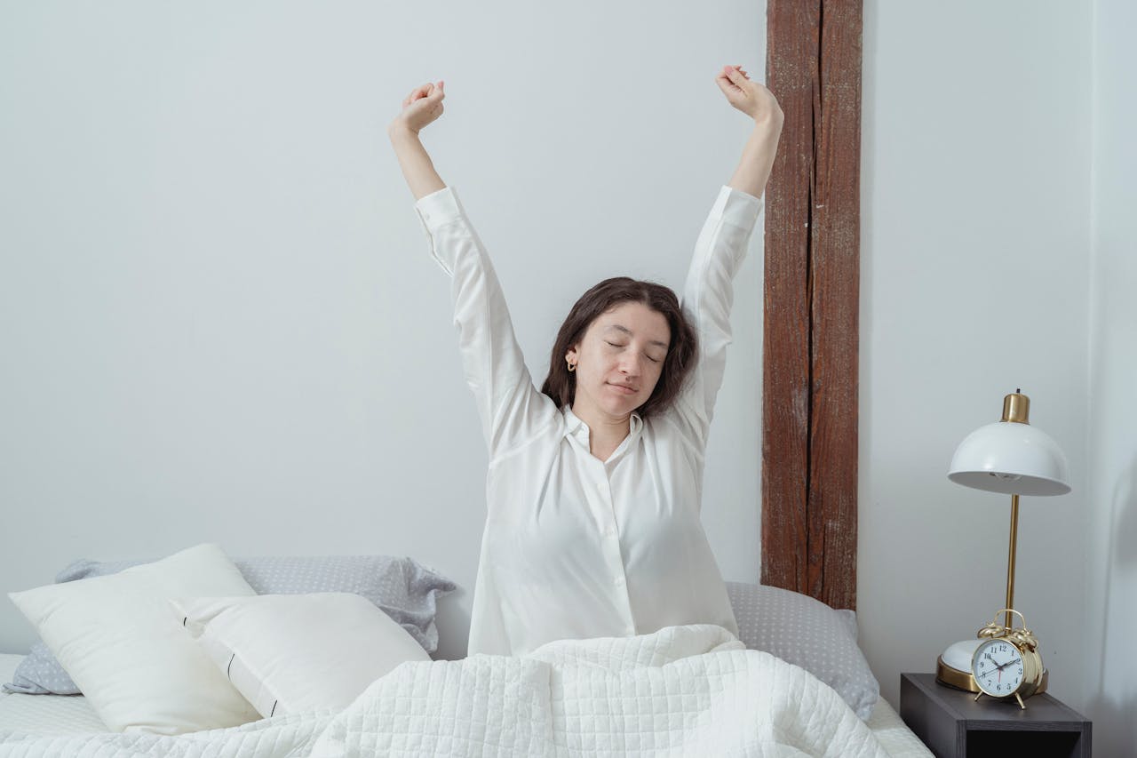 sleepy-woman-waking-up-on-bed-in-morning-