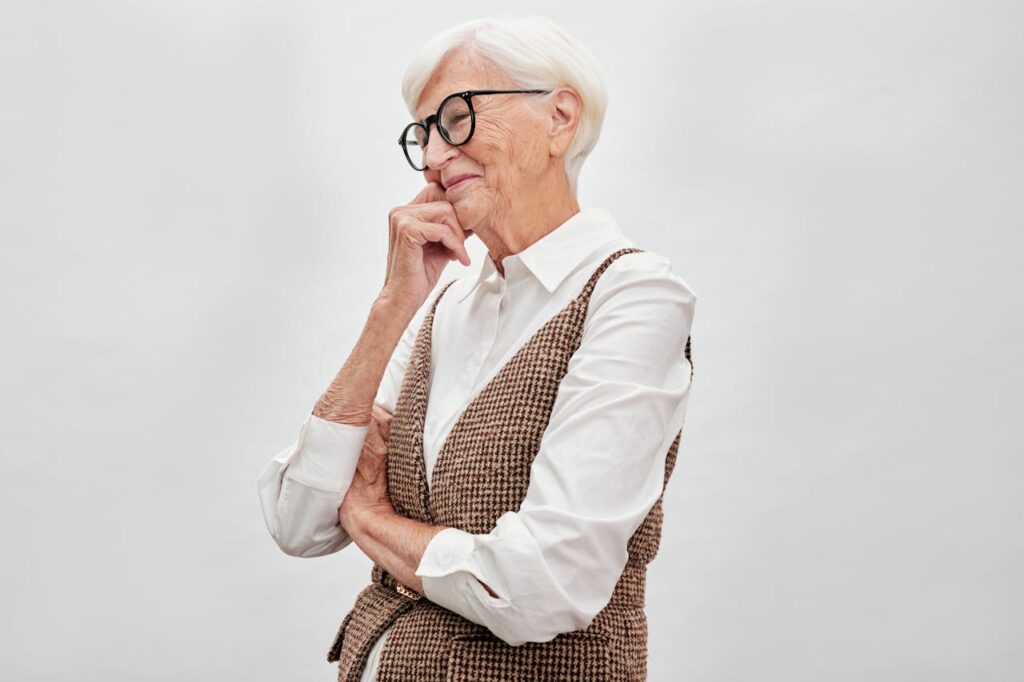 /an-elderly-woman-in-sunglasses-smiling-and-posing-