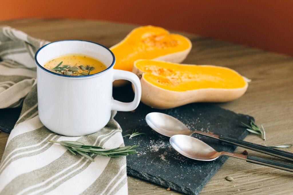 white-ceramic-mug-near-stainless-steel-spoon-