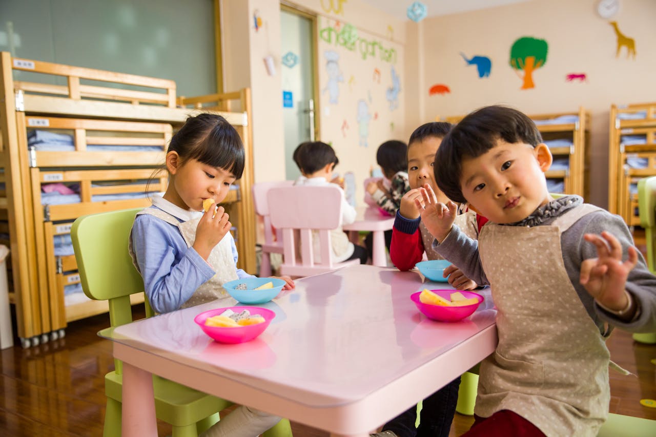 hree-toddler-eating-on-white-table-