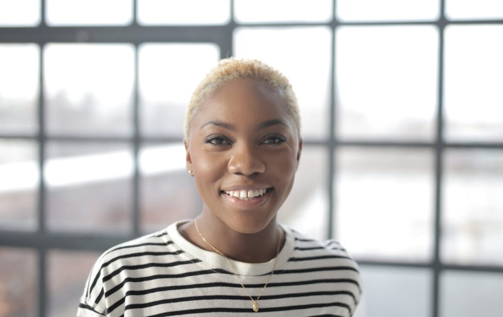 woman-in-black-and-white-striped-crew-neck-t-shirt-smiling