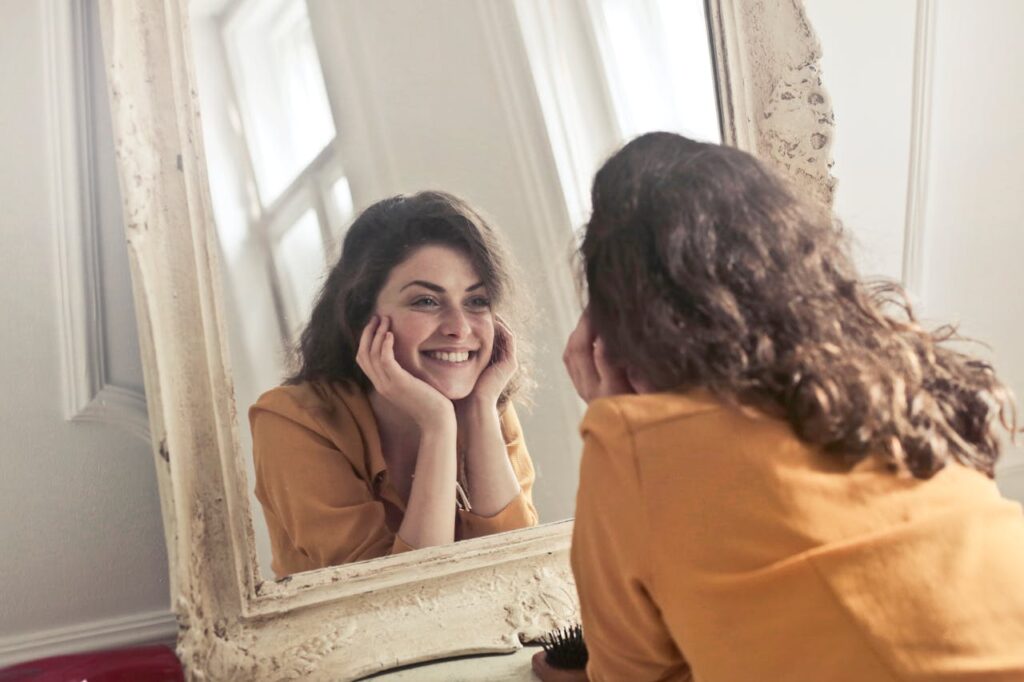photo-of-woman-looking-at-the-mirror
