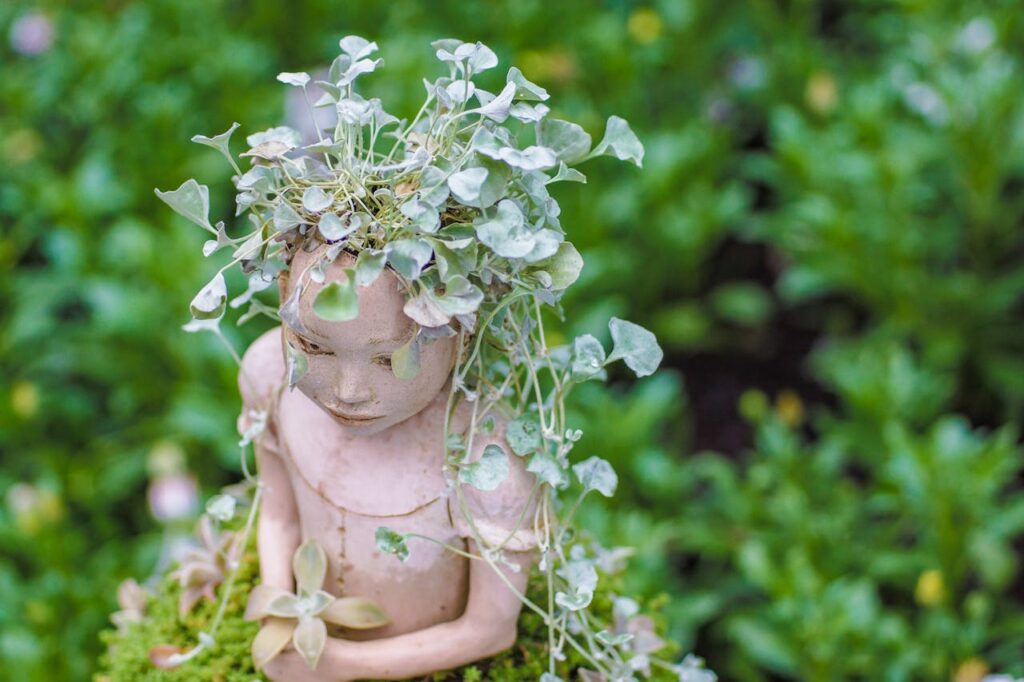 leaves-on-child-sculpture-in-garden-