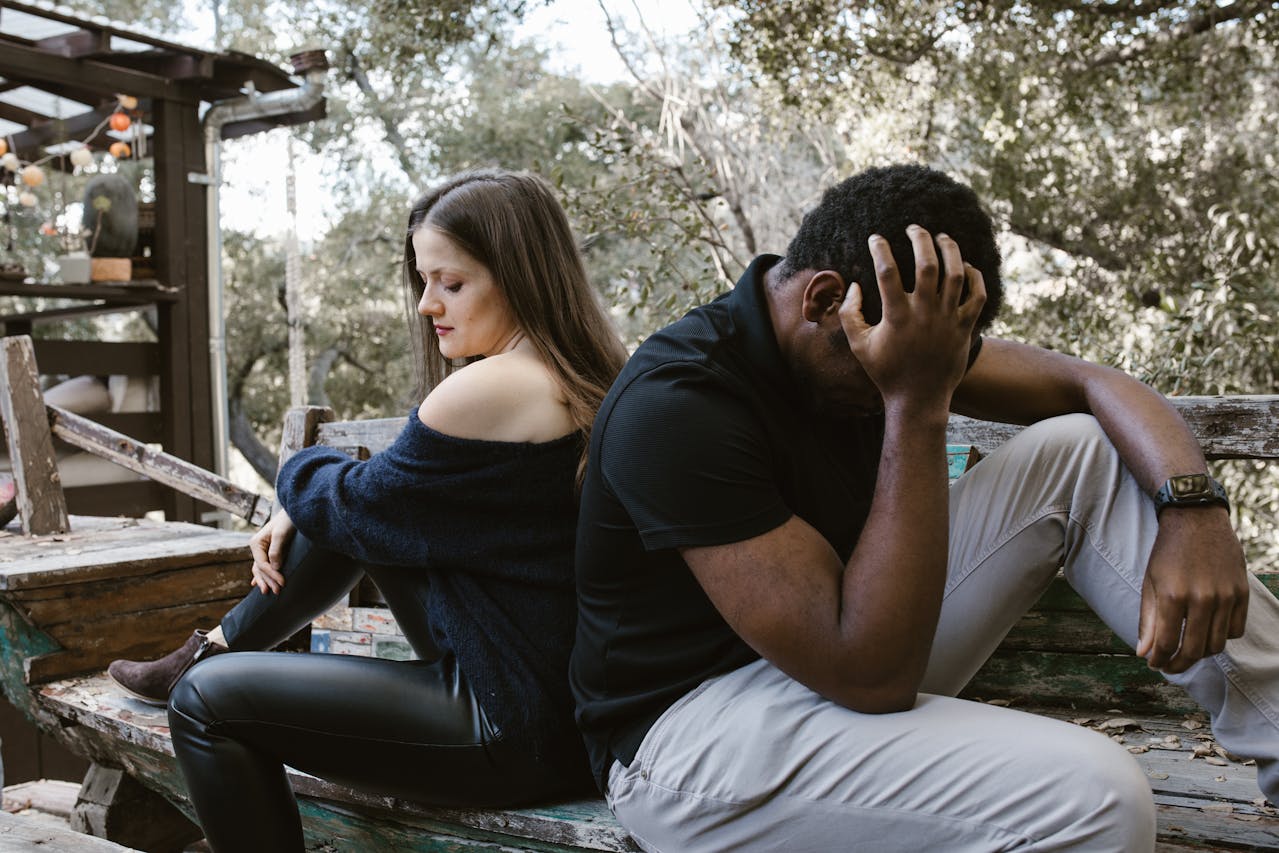 lonely-couple-sitting-back-to-back