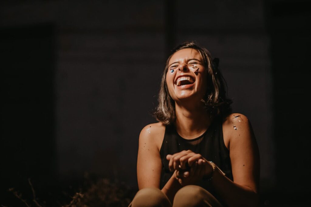 woman-laughing-wearing-black-top-
